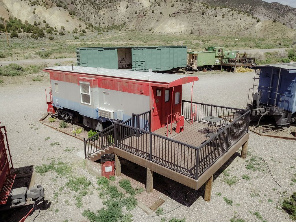 An aerial view of a train car with a deck in front of it.