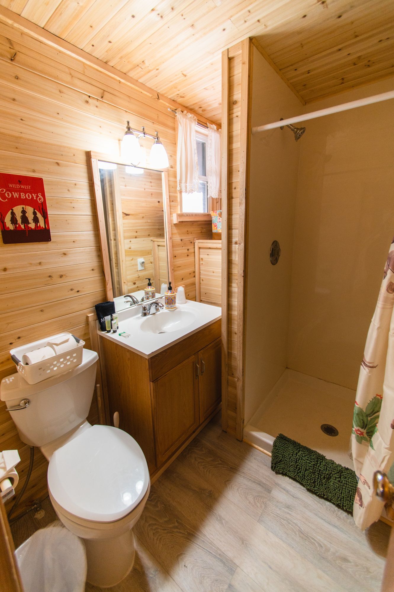 A bathroom with a toilet , sink , and shower.