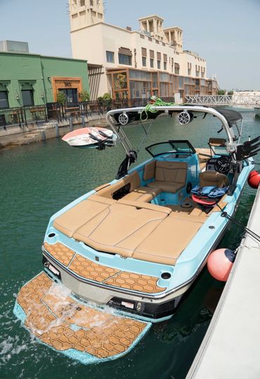 two riders wakeboarding in dubai in clear waters and flat water.