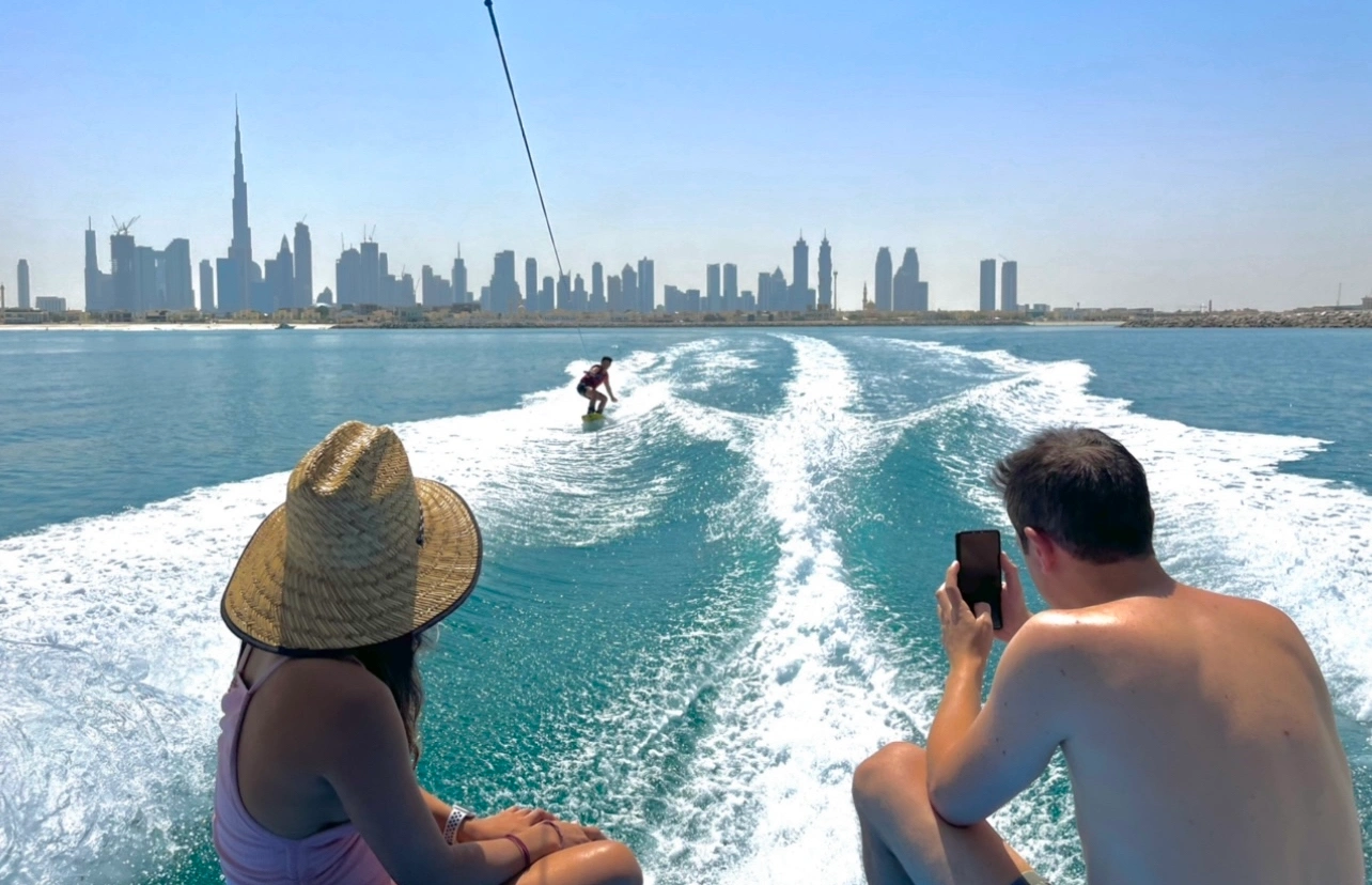 Wakeboarding on blue water with Dubai skyline in the background