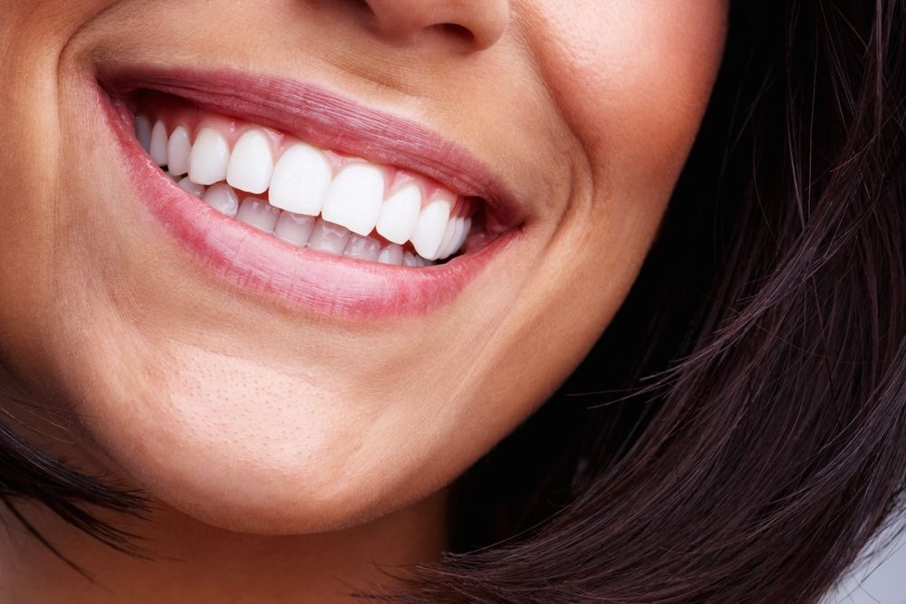 Close-up of a Smiling Mouth Showing White Teeth and Pink Lips — Mareeba Dental Centre in Mareeba, QLD