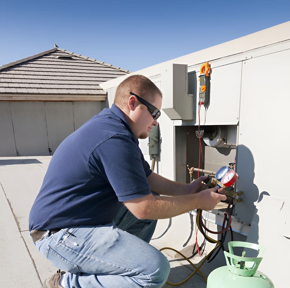 A Man Is Working On An Air Conditioner — BT Airconditioning In Smithfield, QLD