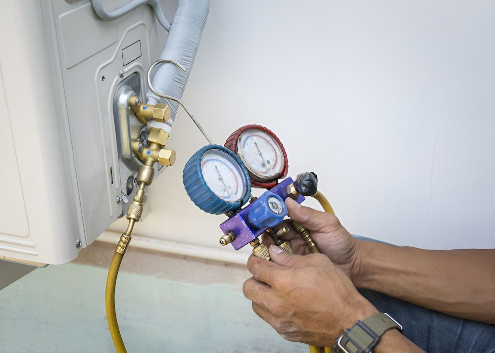 A Man Is Working On An Air Conditioner — BT Airconditioning In Edge Hill, QLD