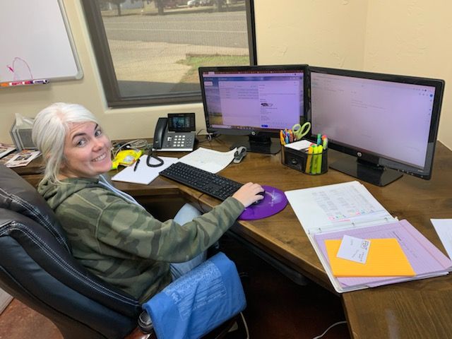 woman seated at Crownline offices desk