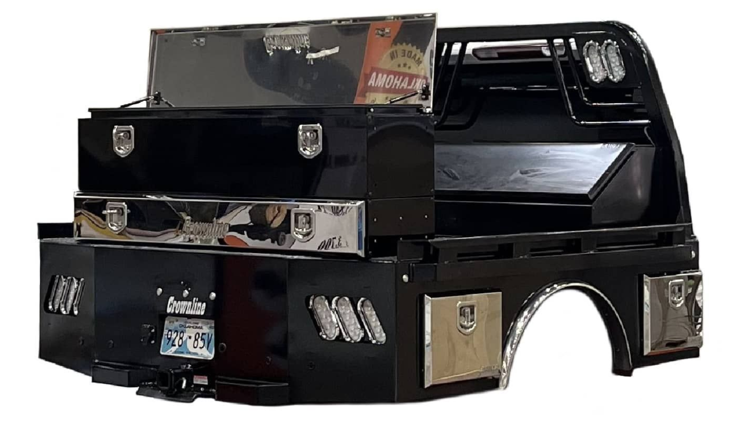 A black truck bed with a stainless steel toolbox on top of it.
