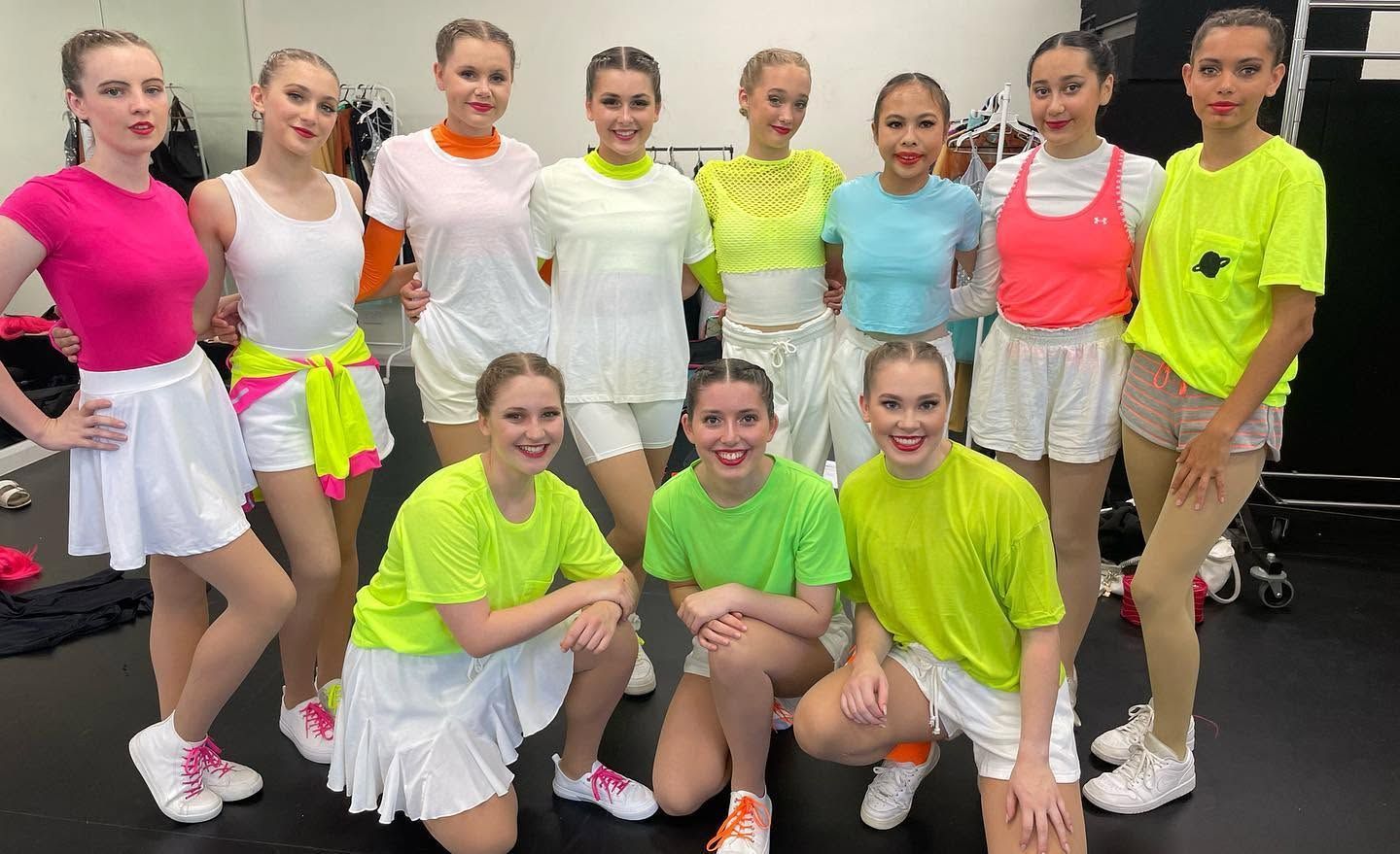 Group of Young Dancers Posing Indoors in Neon Workout Outfits — Kay Flynn Dancing Academy Southport in Southport, QLD