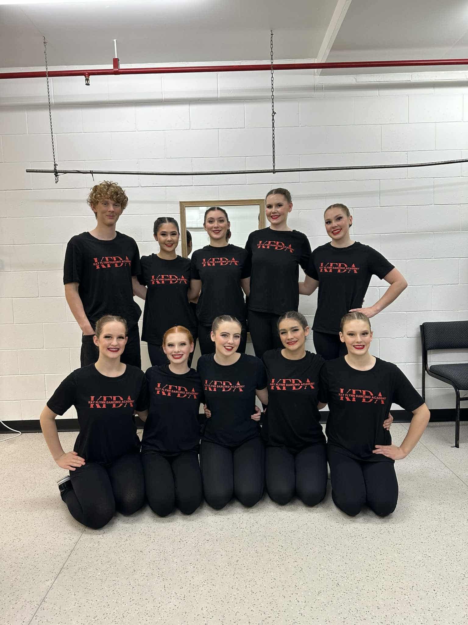 Dance Team in Black Tops and Leggings Posing in a Studio — Kay Flynn Dancing Academy Southport in Southport, QLD