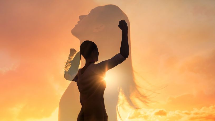 Silhouette of a person raising an arm at sunset with a glowing sky and faint profile overlay