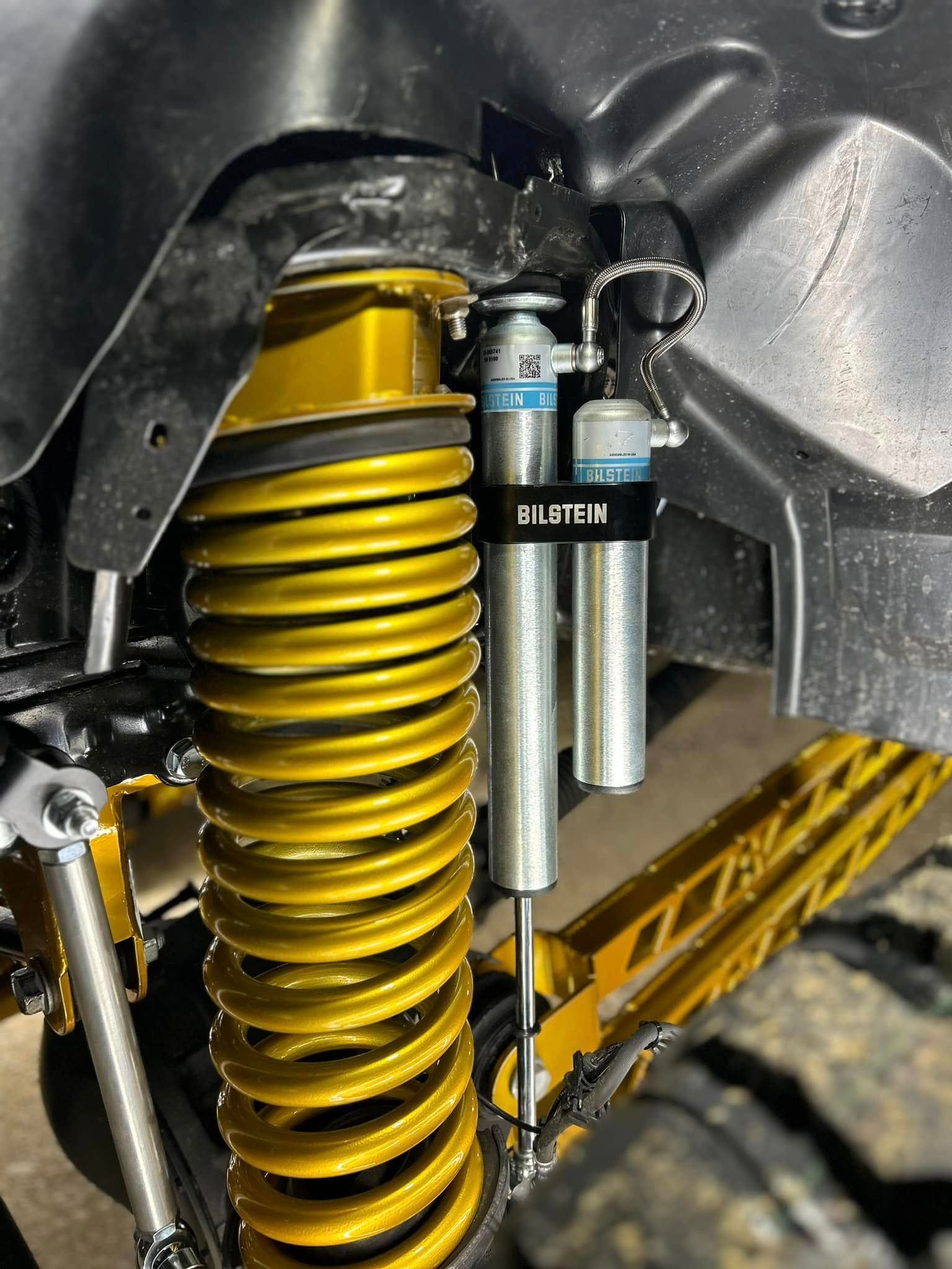 A close up of a suspension system on a truck.