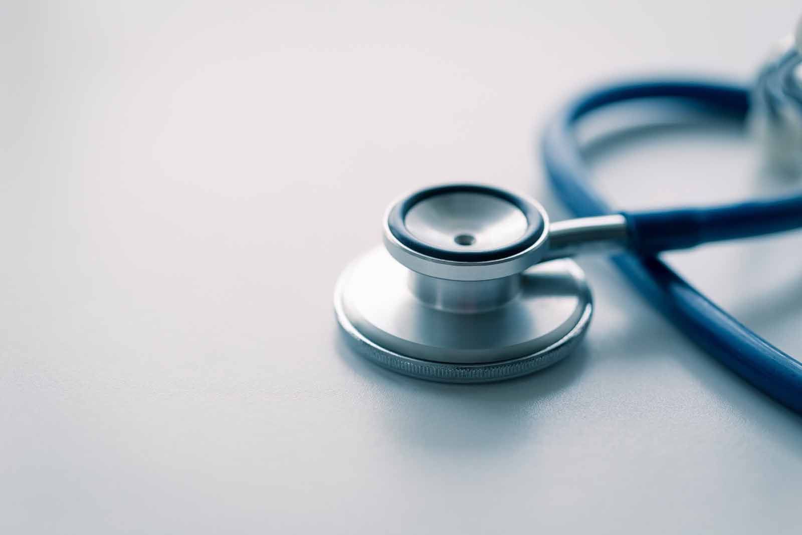 A close up of a stethoscope on a white surface.