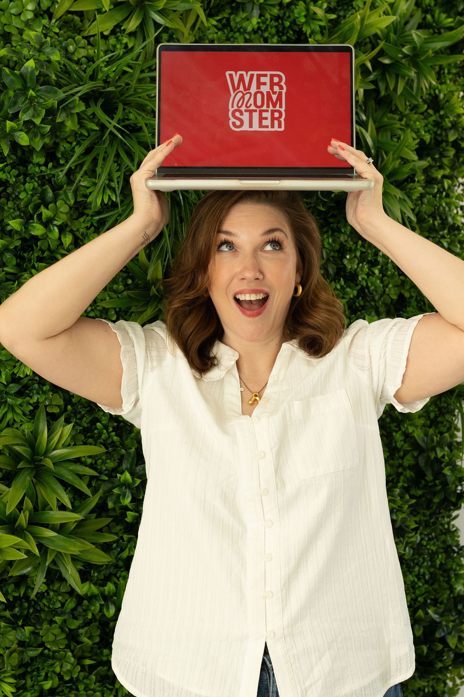 Alida Lee holding a Web Momster laptop