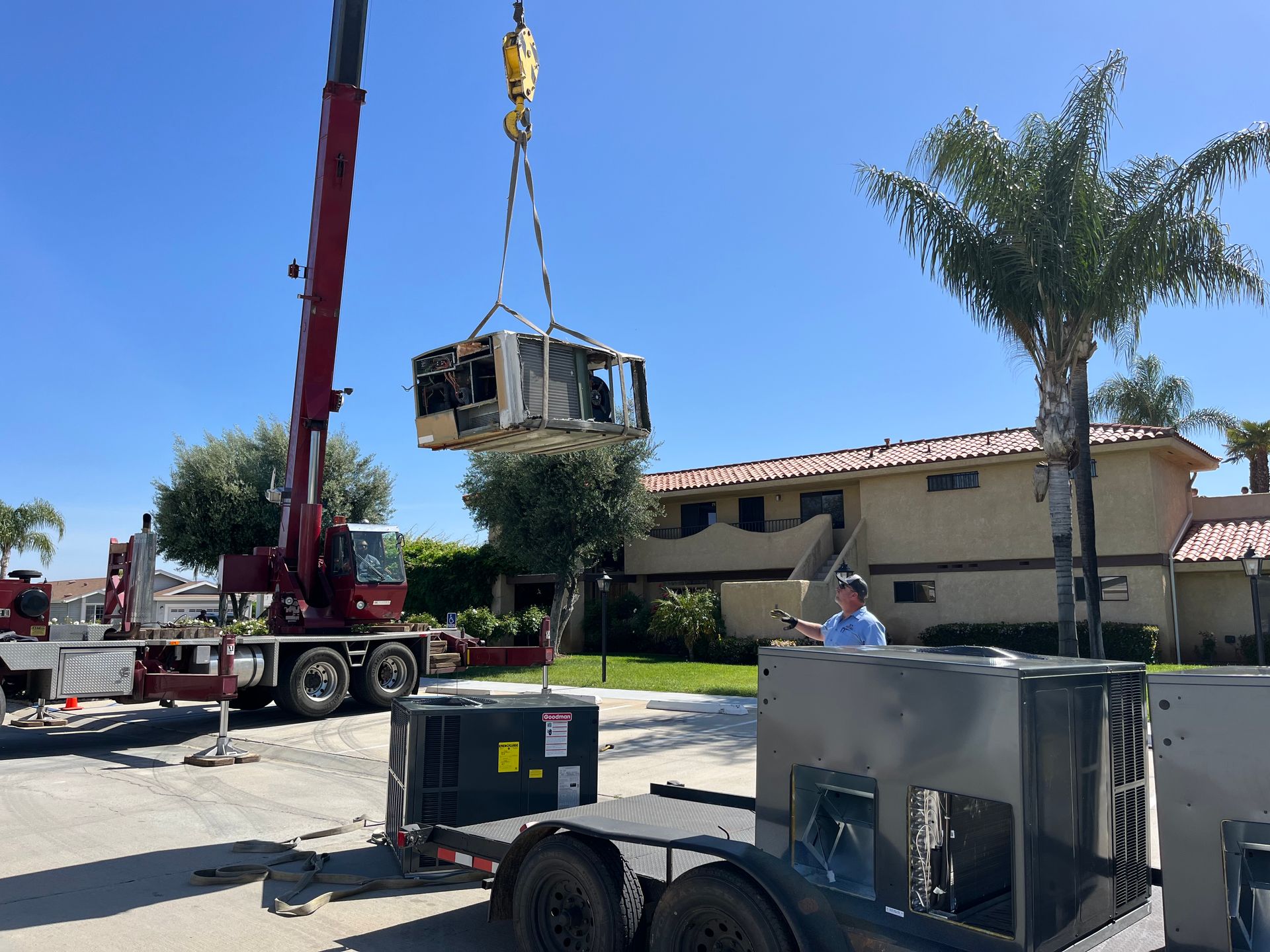A man is working on a carrier air conditioner on a roof