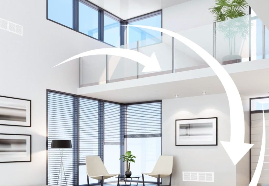 Bright modern office interior with glass railings, skylights, chairs, and large white arrows indicating movement
