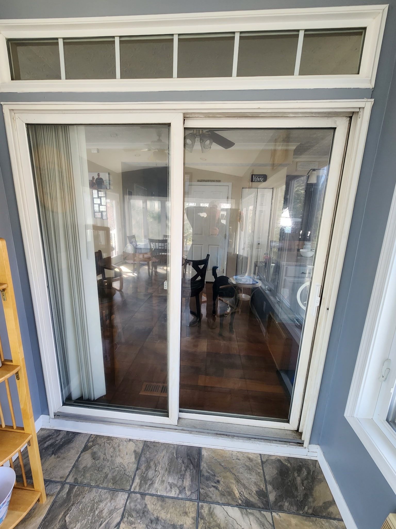 Sliding glass patio doors with white trim opening into a hardwood-floored living room