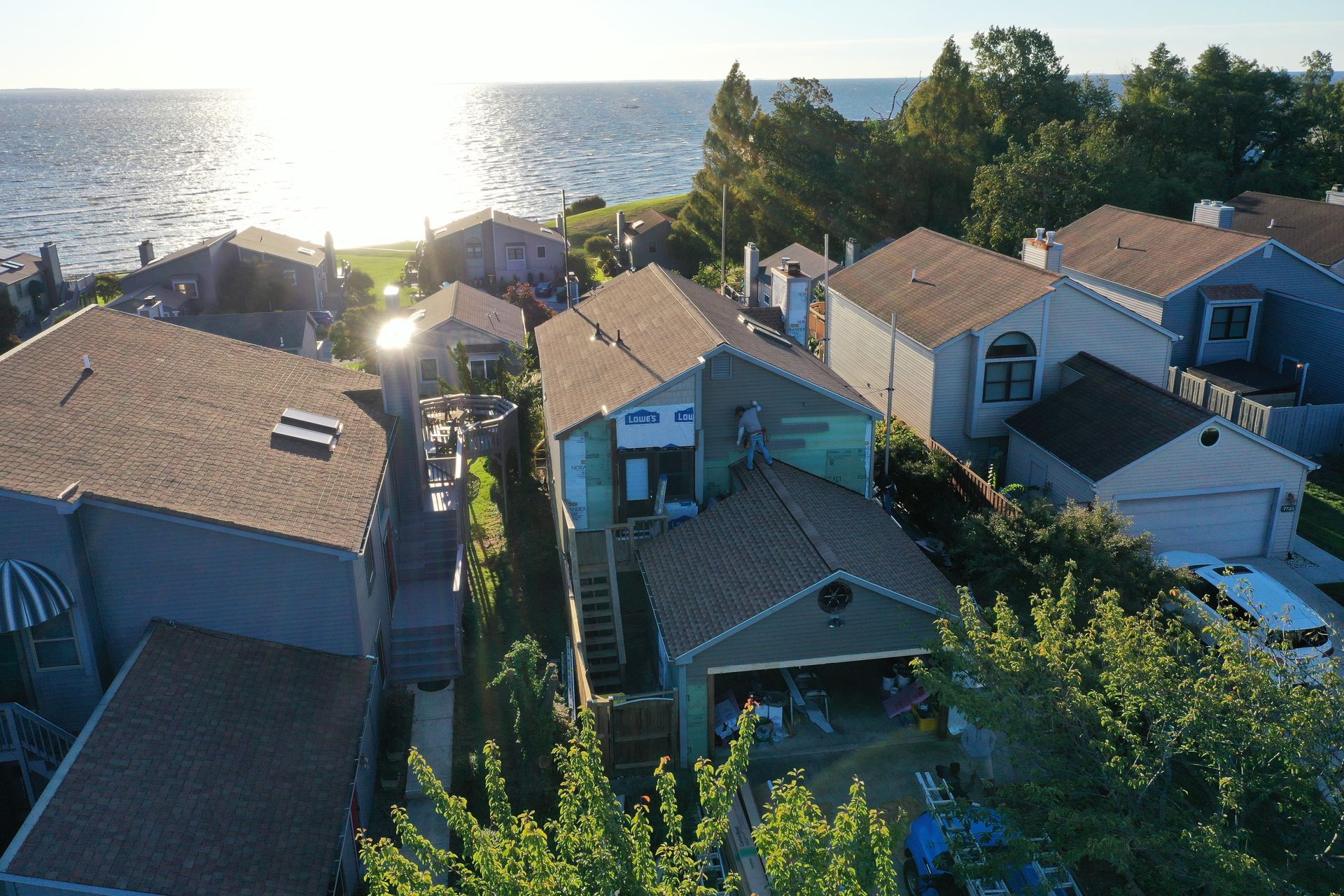 Sunlit coastal neighborhood with rooftops overlooking the ocean