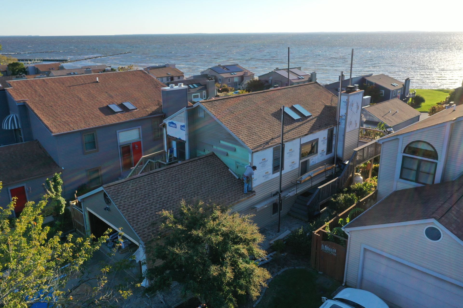 Houses with red roofs overlooking the ocean at sunset