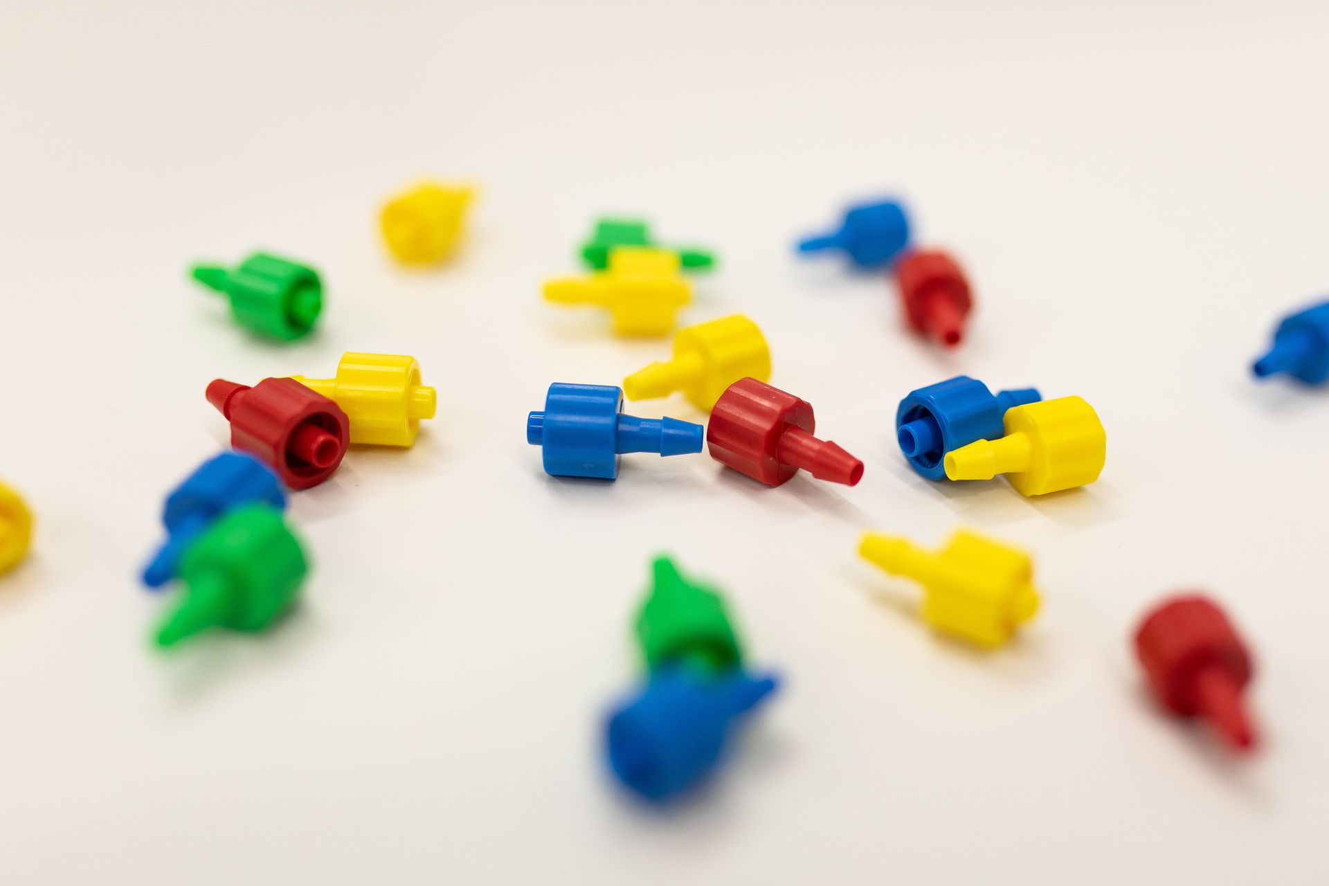 small plastic parts scattered on a white table