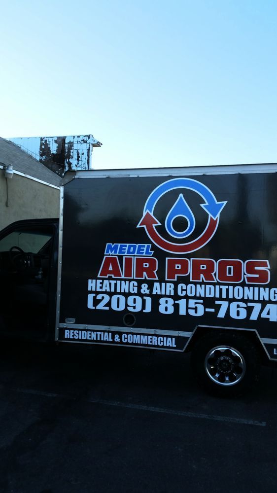 Black Air Pros heating and air conditioning service truck with logo and phone number parked outdoors