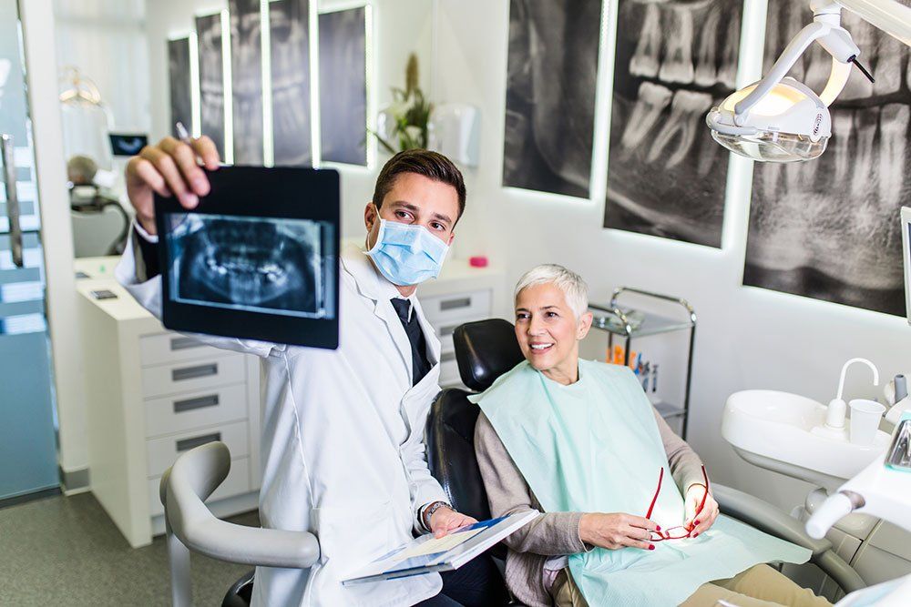 Dentist Showing the X-ray to the Patient — Palm Bay, FL — Babcock Dental Center LLC