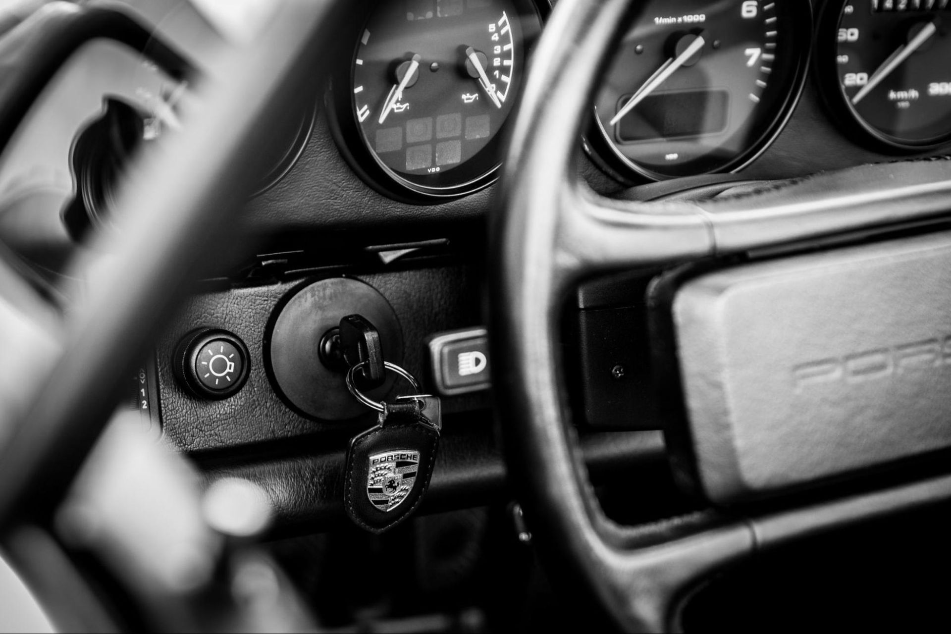 A black and white photo of the dashboard of a porsche 911.