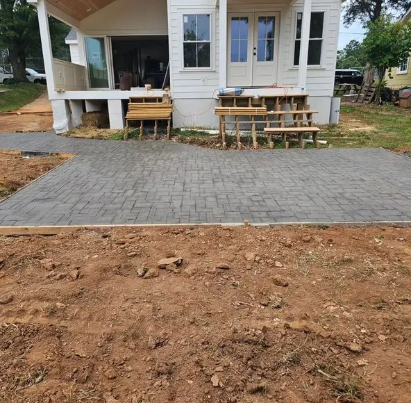 A white house with a brick driveway in front of it