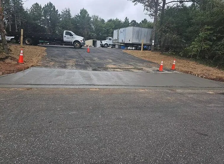 A truck is parked on the side of the road next to a concrete ramp.