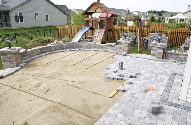 A playground is being built in the backyard of a house