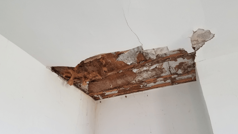 Photo of a ceiling with damaged drywall.