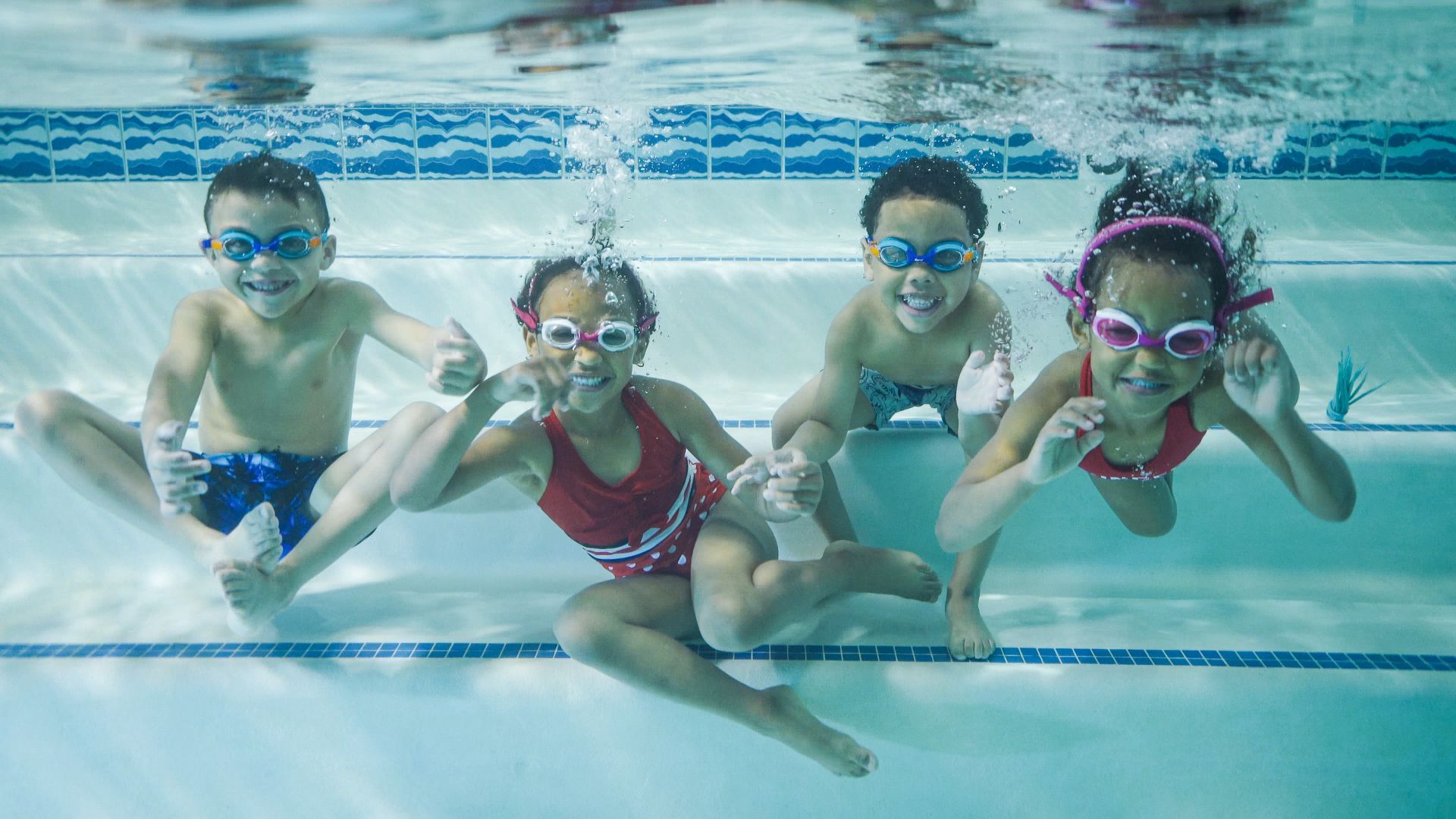 Kids happy swimming underwater.