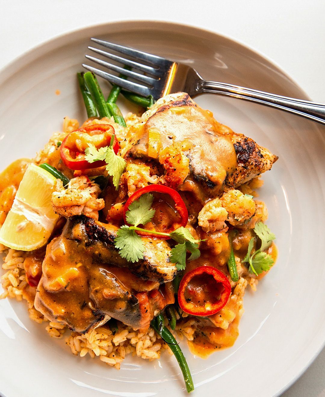 A close up of a plate of food with a fork on it