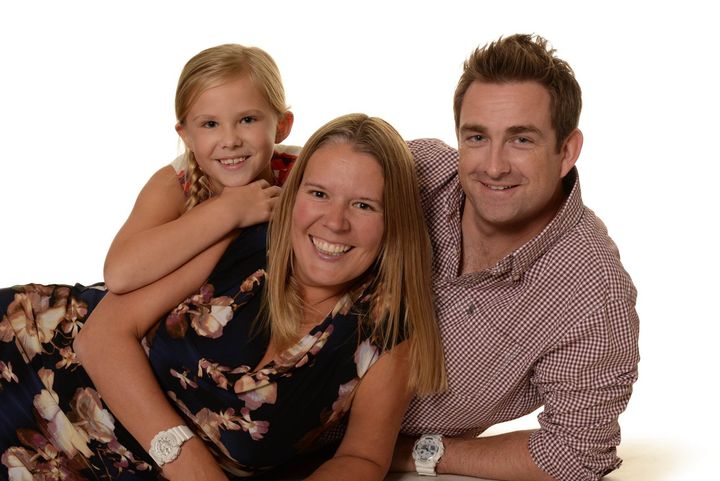 Various photographs including a family portrait, a child portrait, a child group photograph and branded school goods.