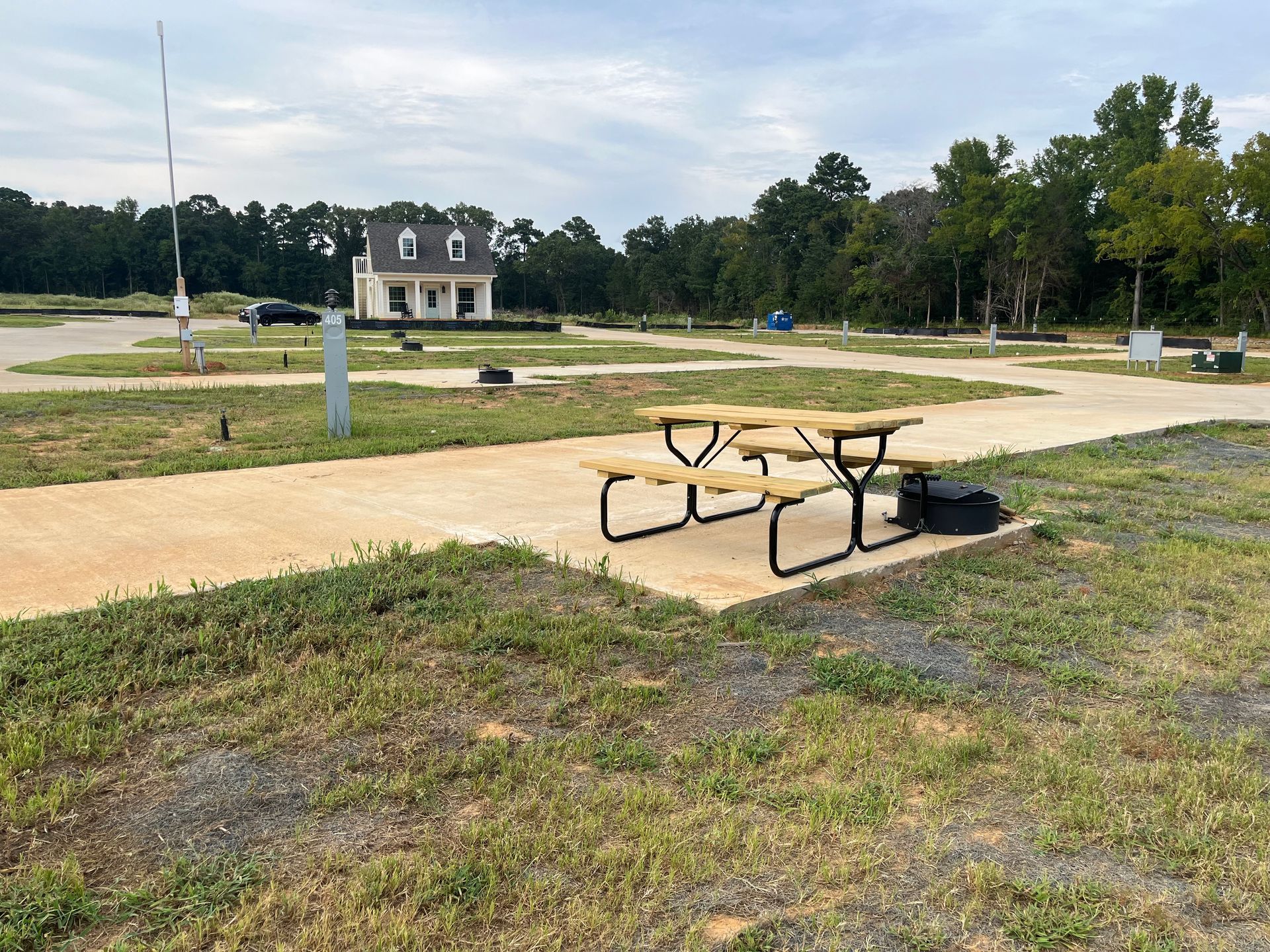 A picnic table is sitting in the middle of a grassy field.