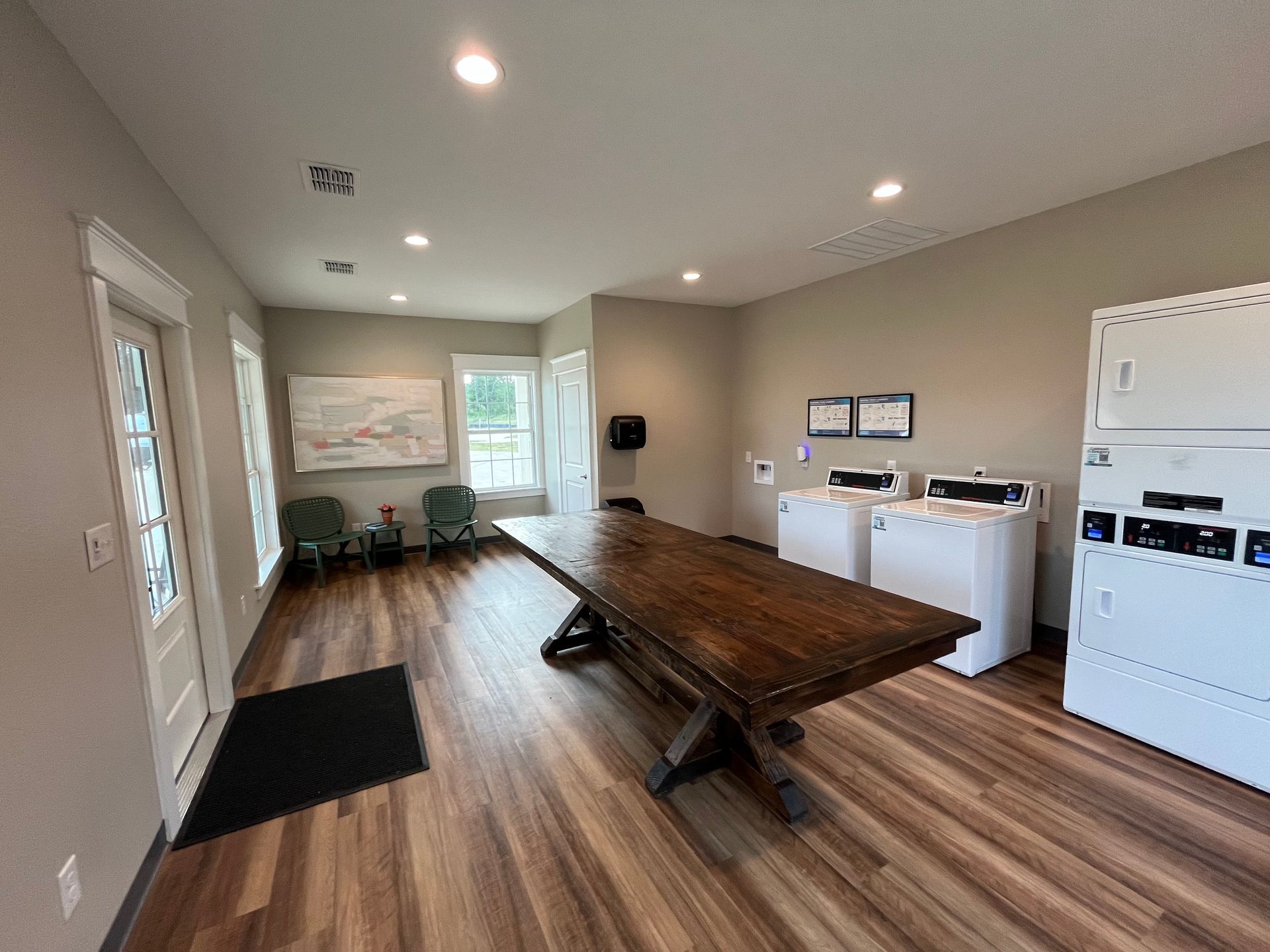 There is a large wooden table in the middle of the room.