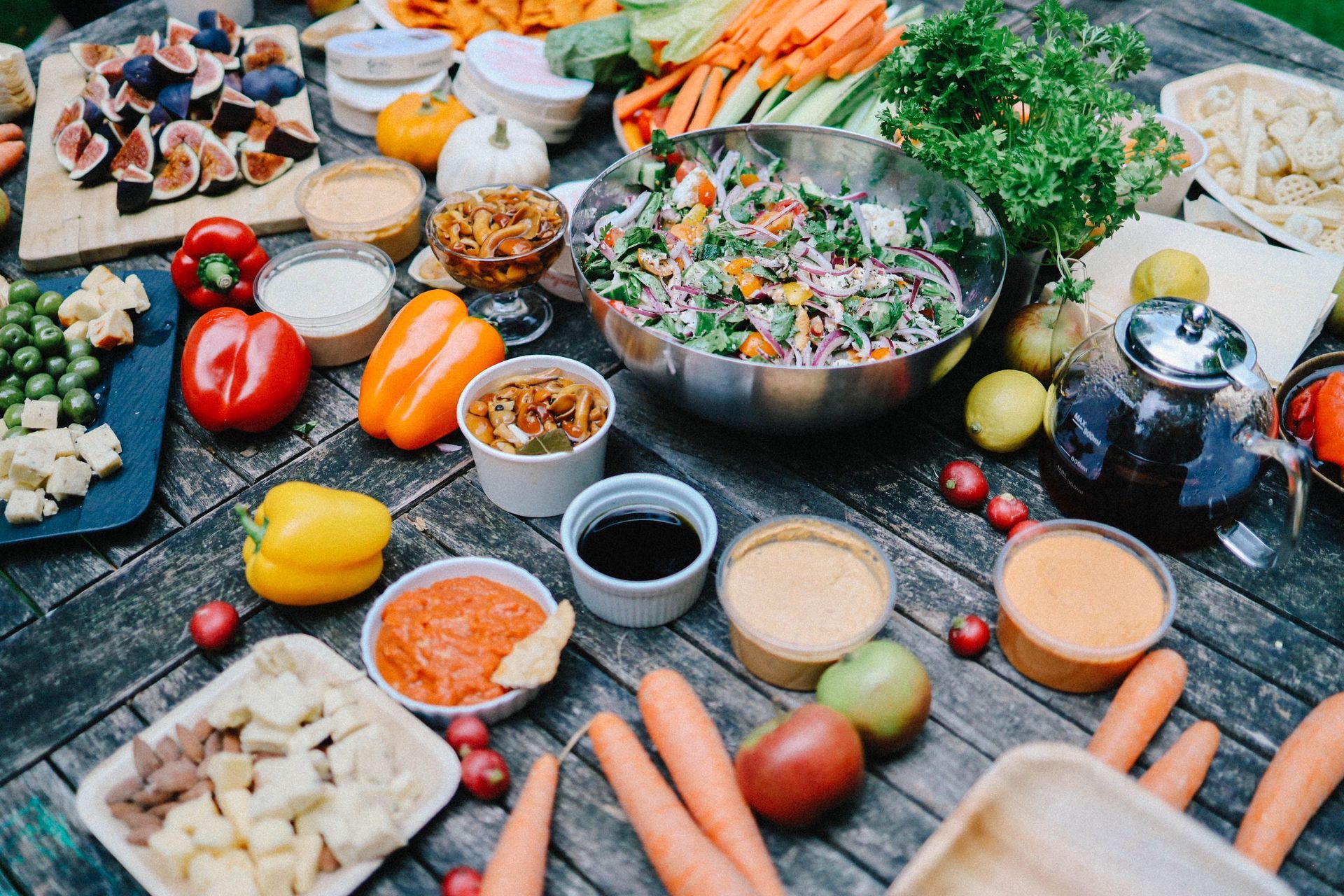 vibrant selection of fresh vegan fruits vegetables and grains arranged on a rustic wooden table overhead view flat lay