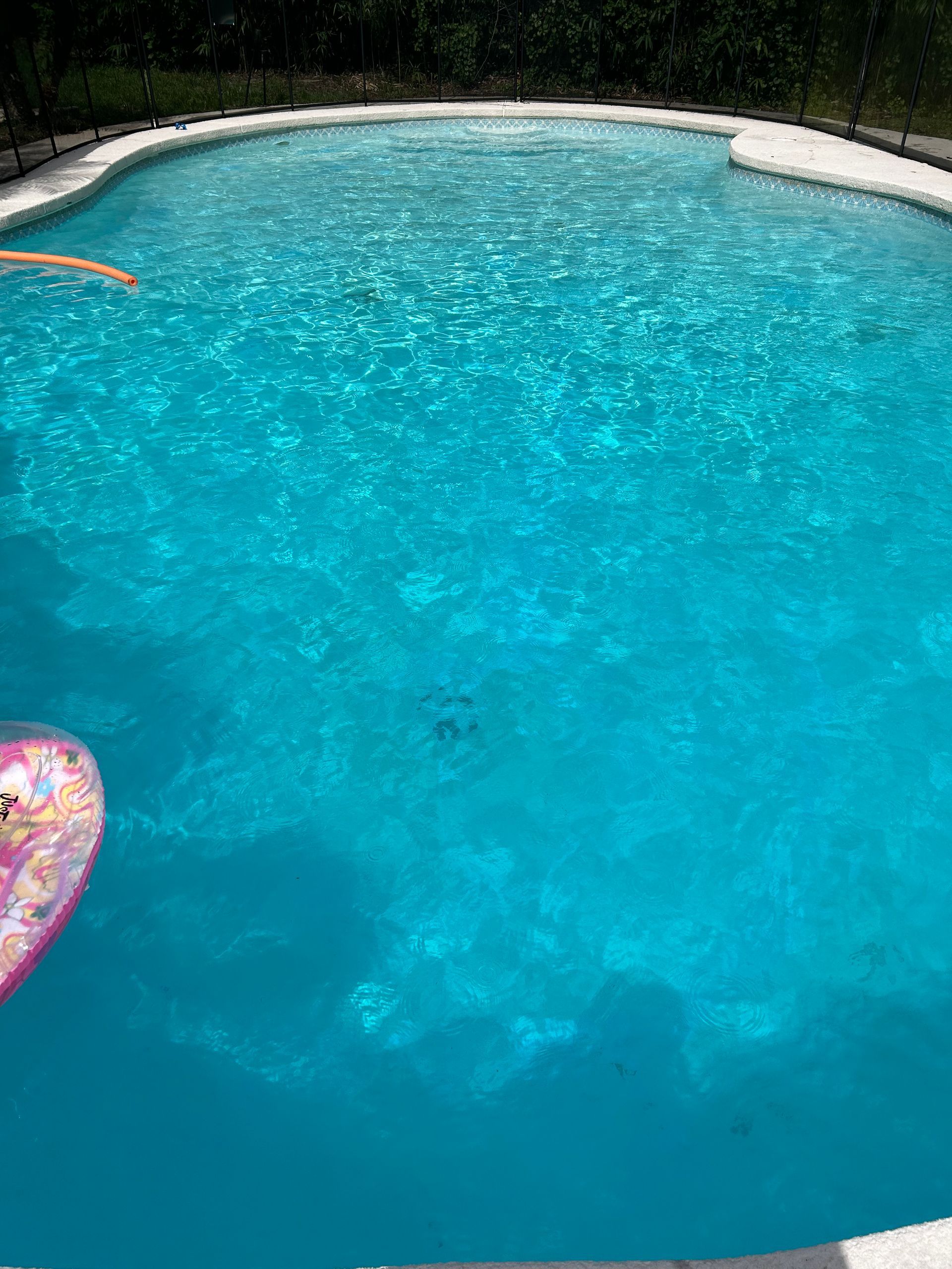 A person is swimming in a large swimming pool.