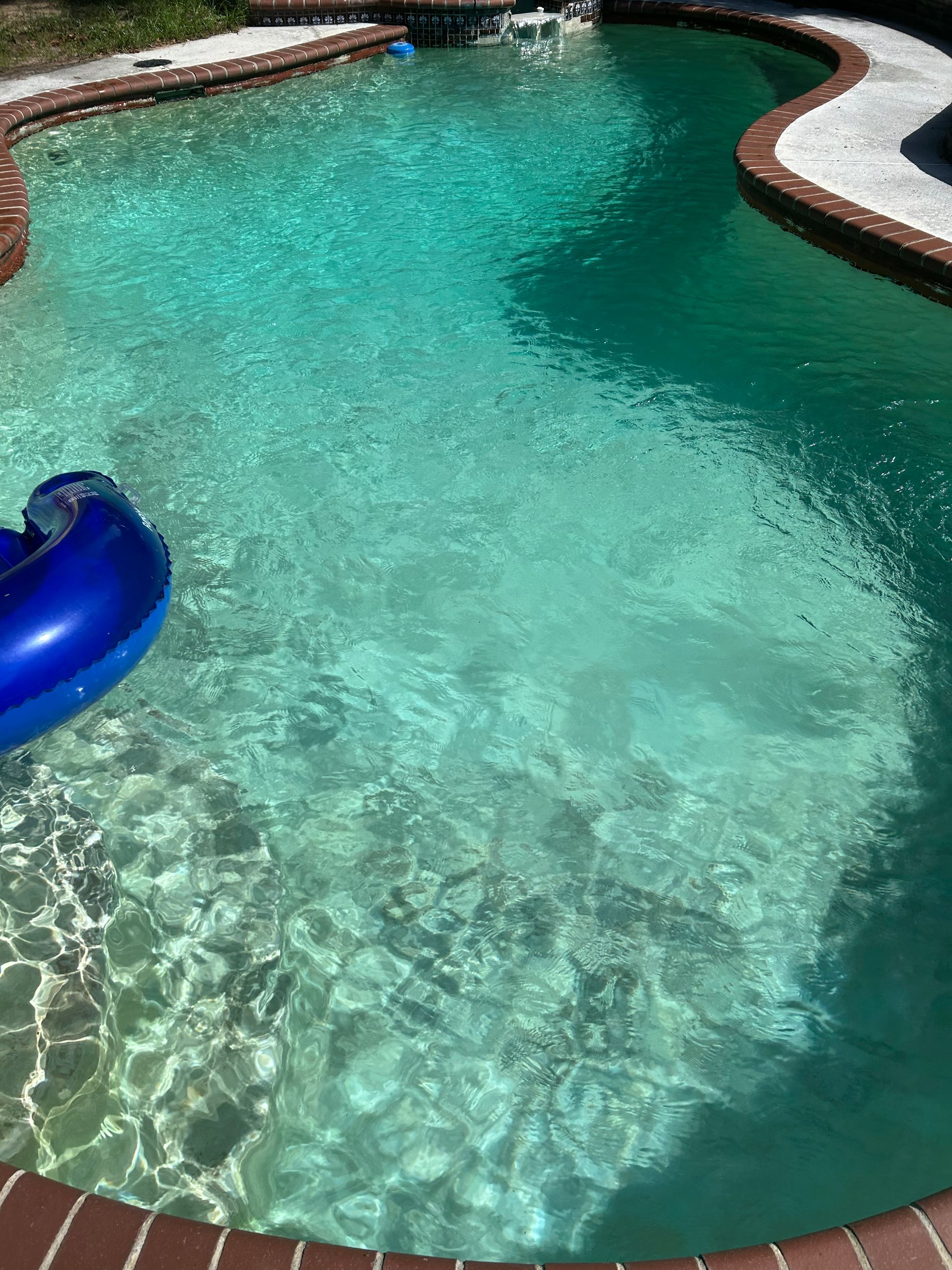 A large swimming pool with a blue float in it.