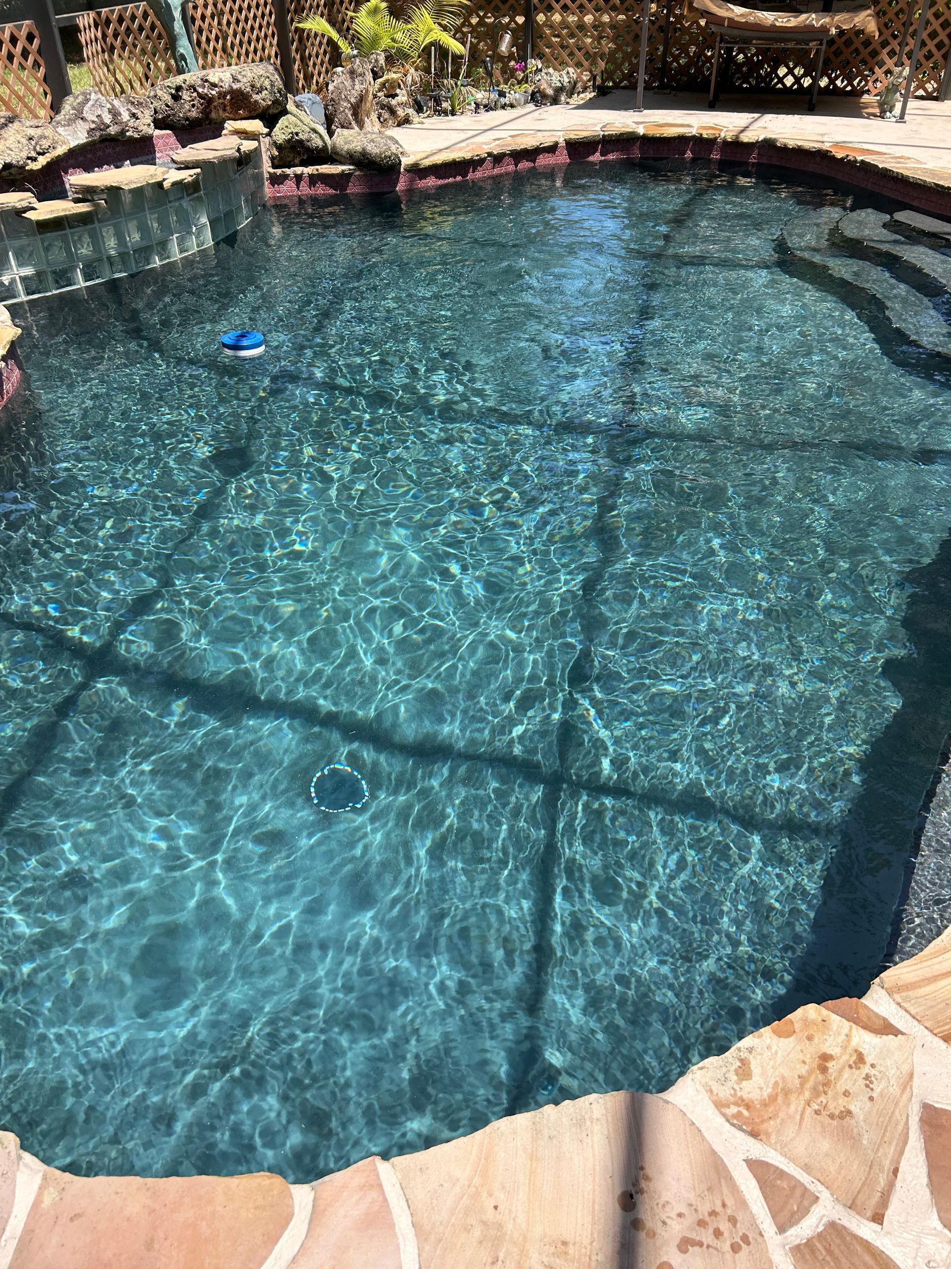 A large swimming pool with a blue float in it.