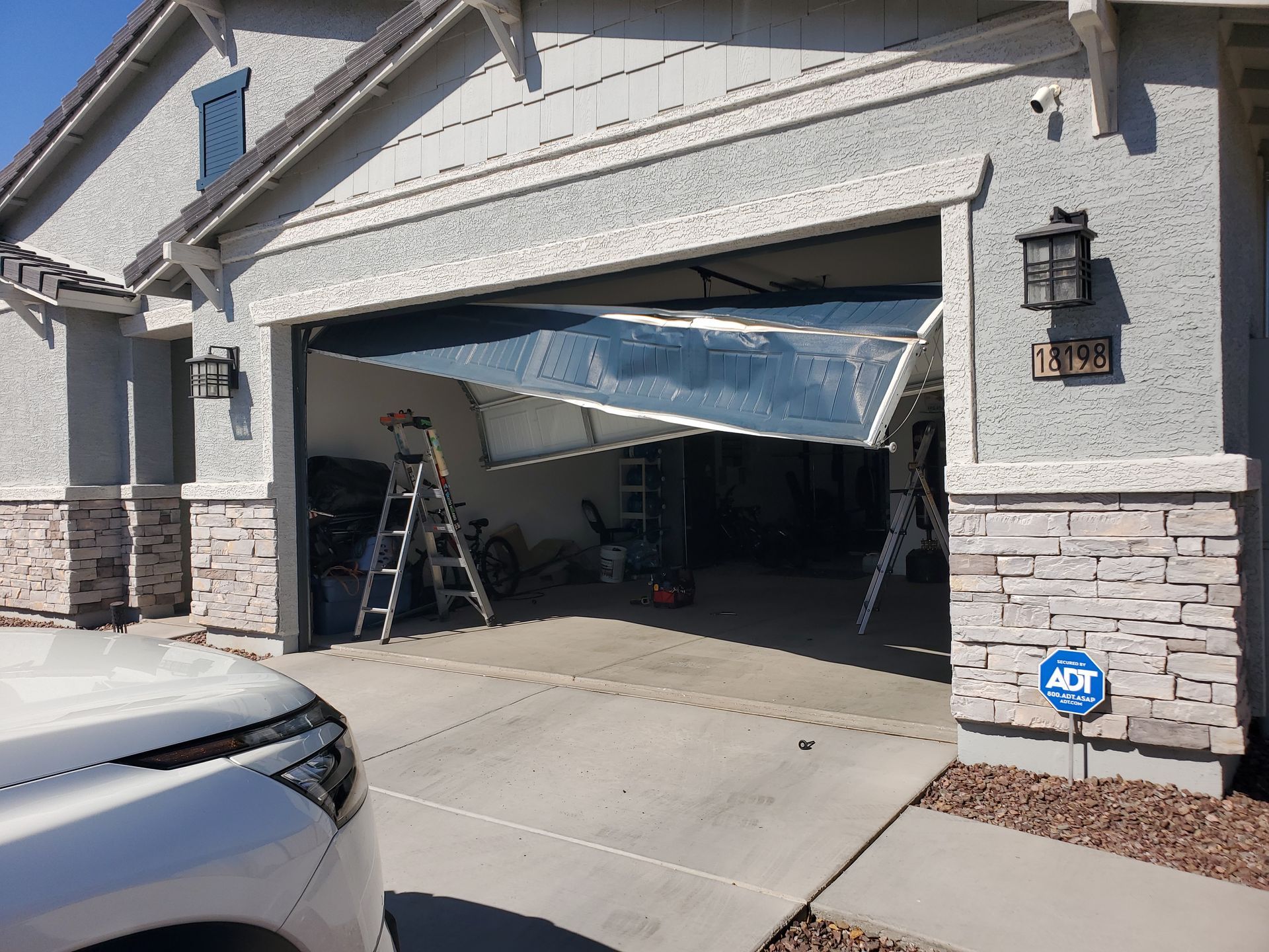 crashed garage door needing replacement in buckeye az