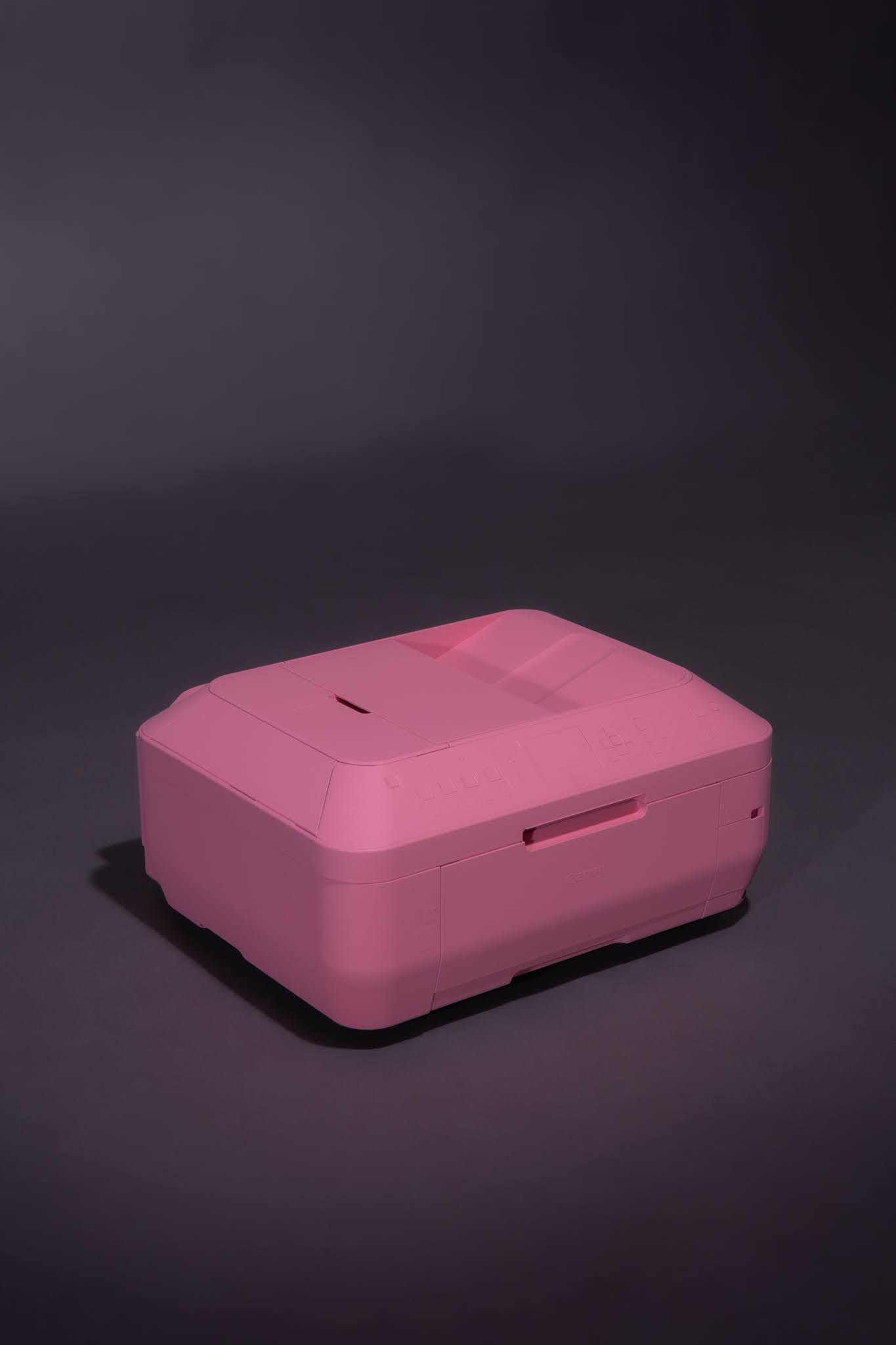 Pink rectangular device on a dark gray surface; art by Matt Remsbecher. 