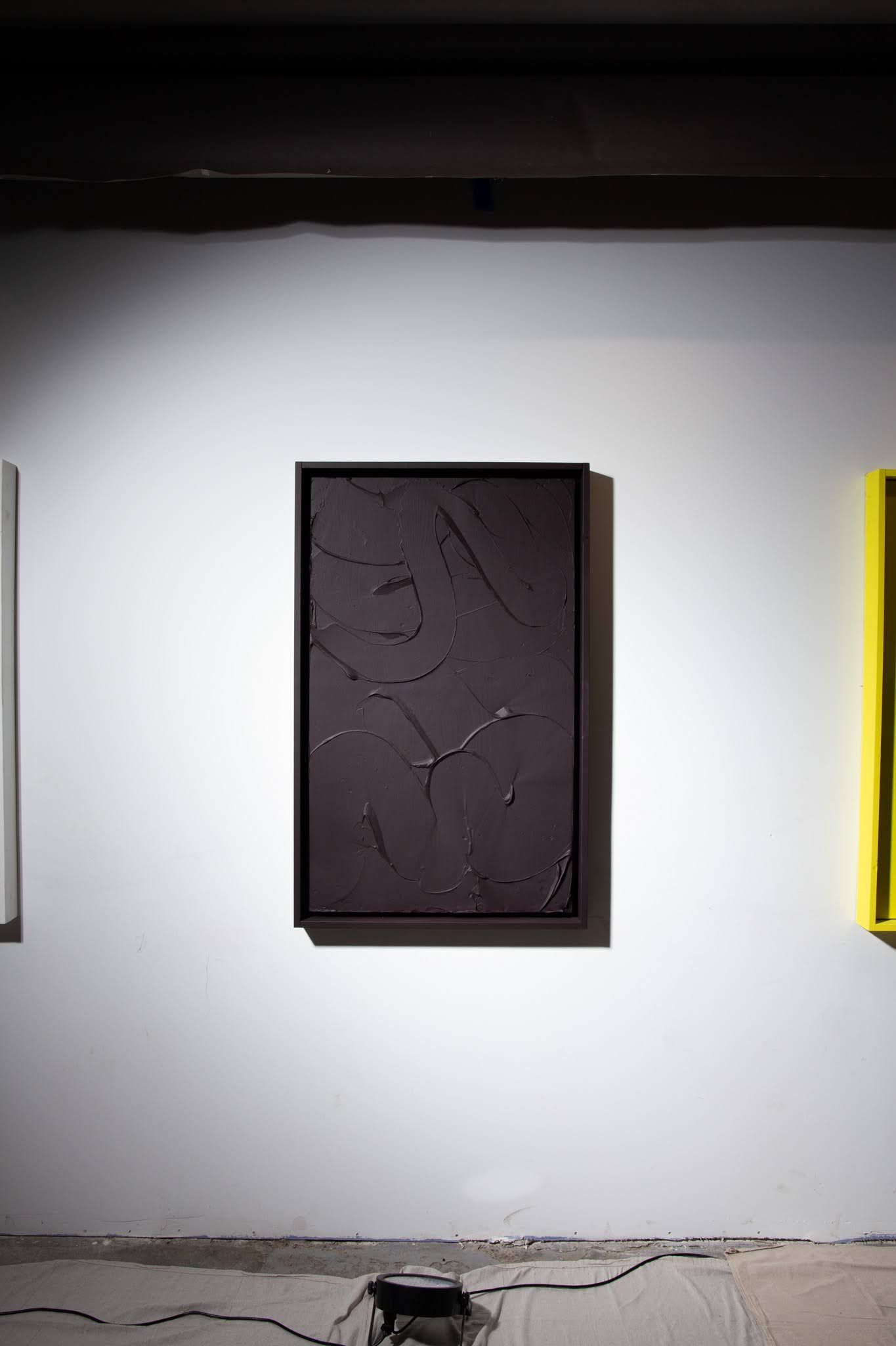 Black rectangular abstract painting on white wall in gallery; art by Matt Remsbecher. 