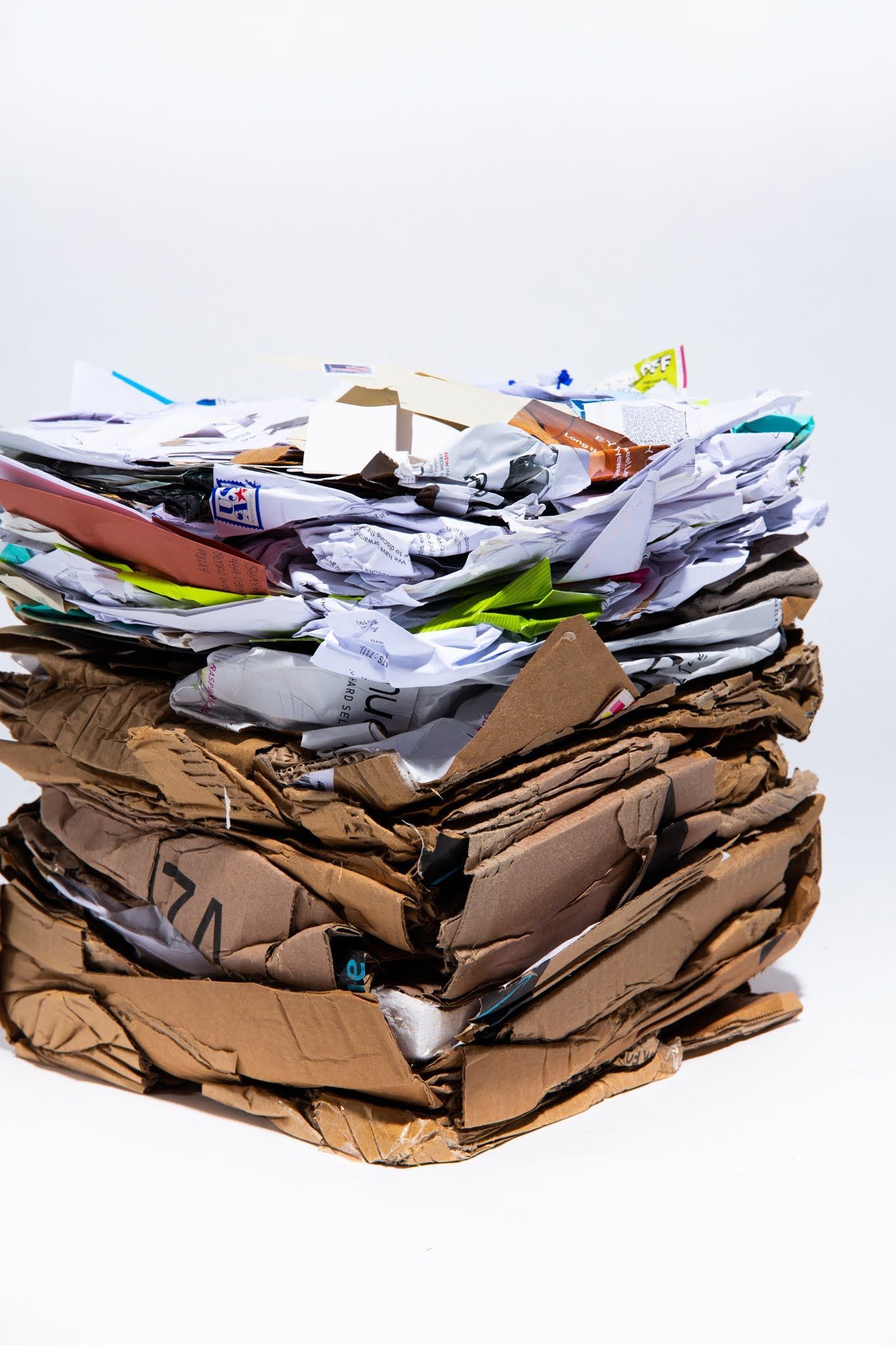 Pile of flattened cardboard boxes and mixed paper against a white background; art by Matt Remsbecher. 