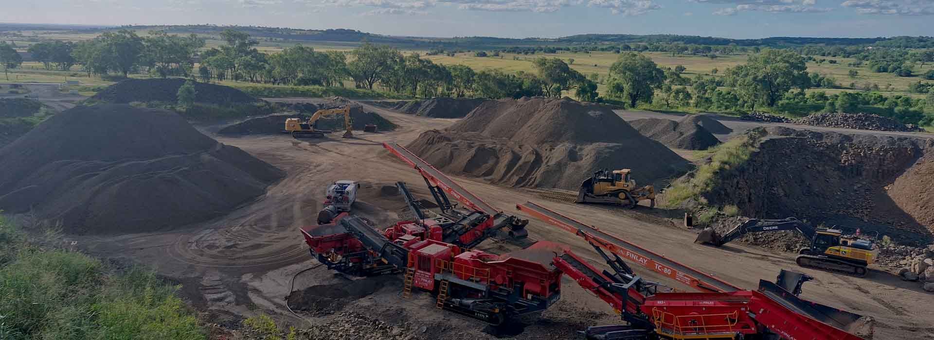 An aerial view of a quarry site with a lot of machinery.