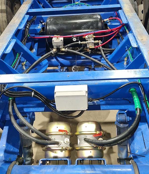 A blue vehicle with a lot of wires coming out of it
