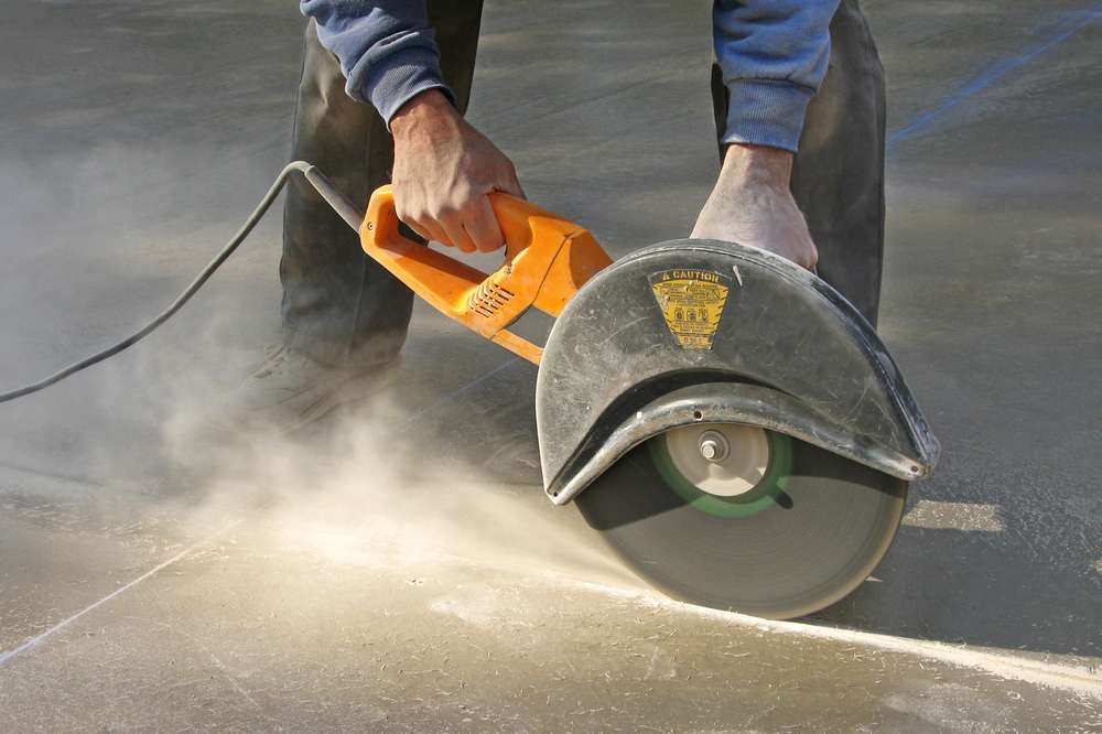 carving a control groove in a slab of concrete