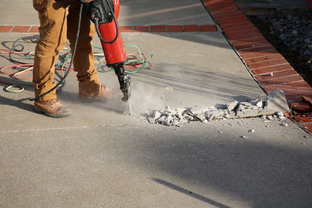 an old cement drive way being demolished to be rebuilt