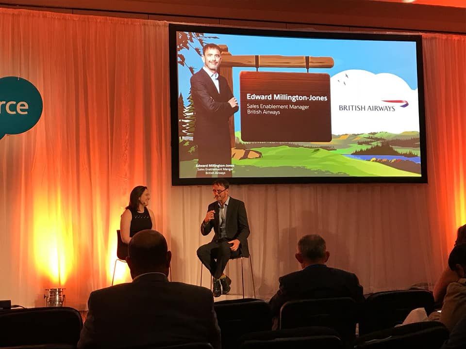 Image of Rebecca Mackenzie interviewing a customer on stage