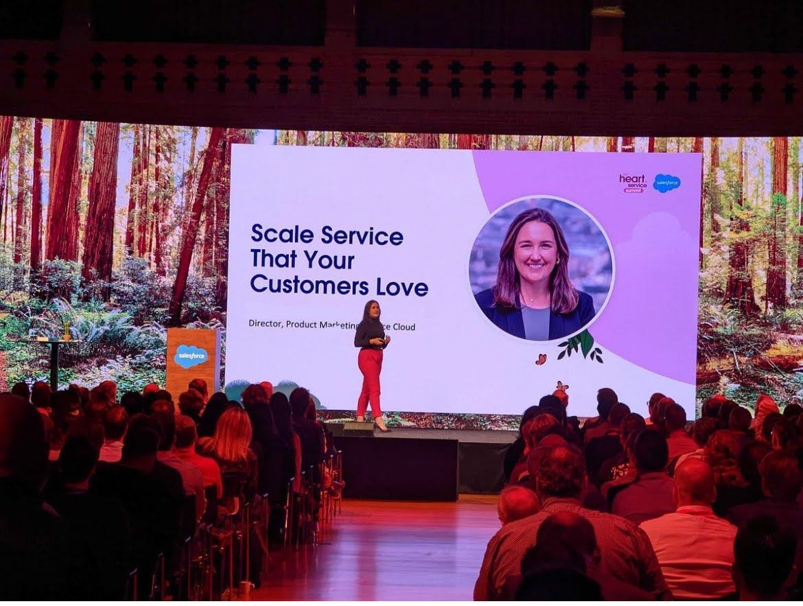 A speaker on stage at a Salesforce conference presents