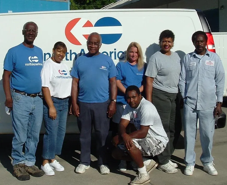 Group of people in front of a white van with 