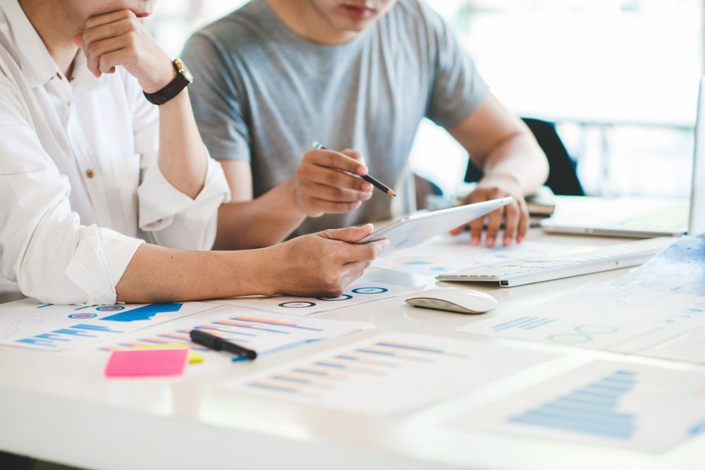 Two People Reviewing Charts and Notes — Compago Technologies In Cambridge, TAS