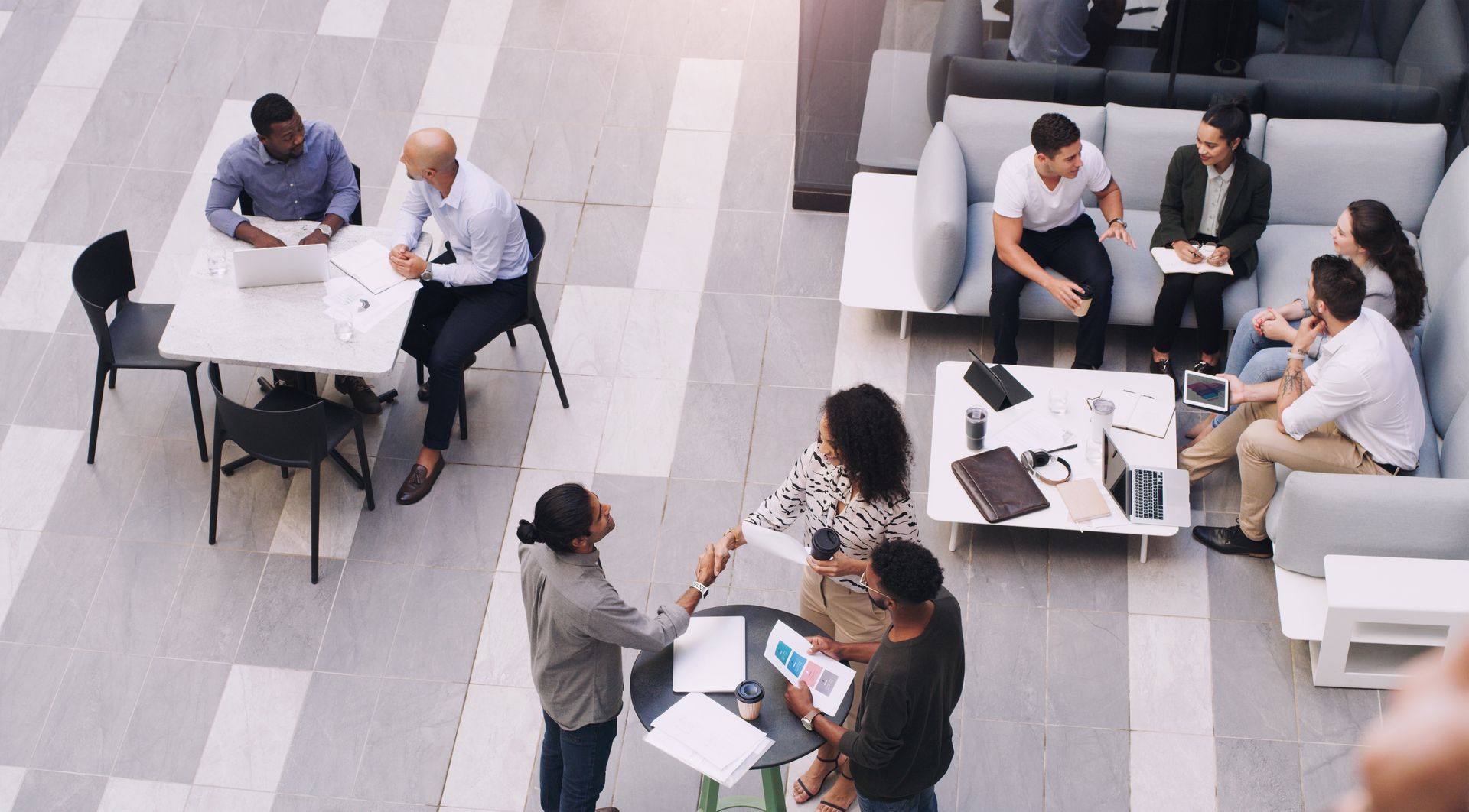 People Working and Talking in a Bright Office Lounge — Compago Technologies In Cambridge, TAS